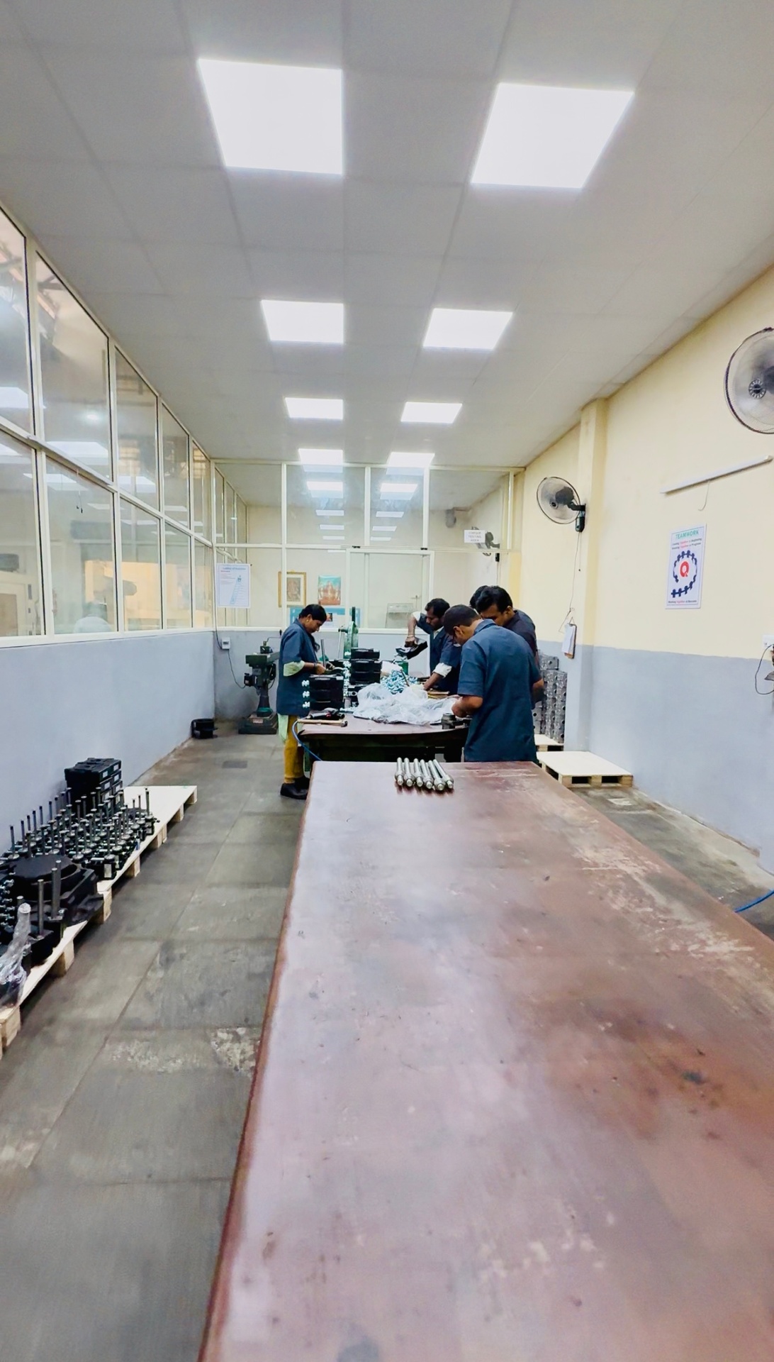 MEI engineer inspecting a precision gearbox assembly on the shop floor
